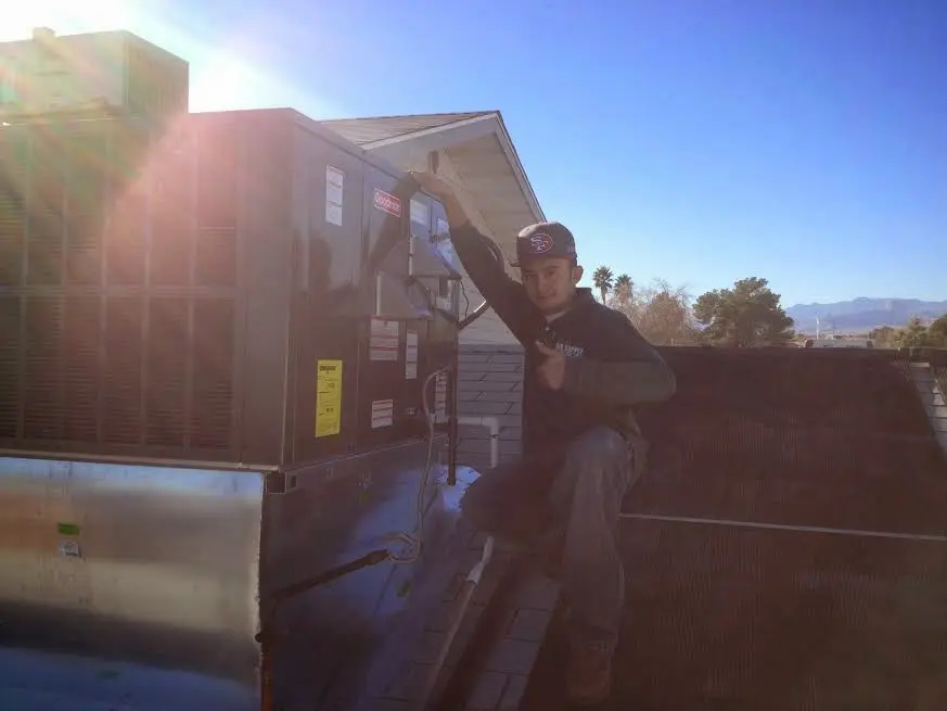 HVAC technician performing HVAC Inspection on a rooftop unit in Upper Mount Bethel